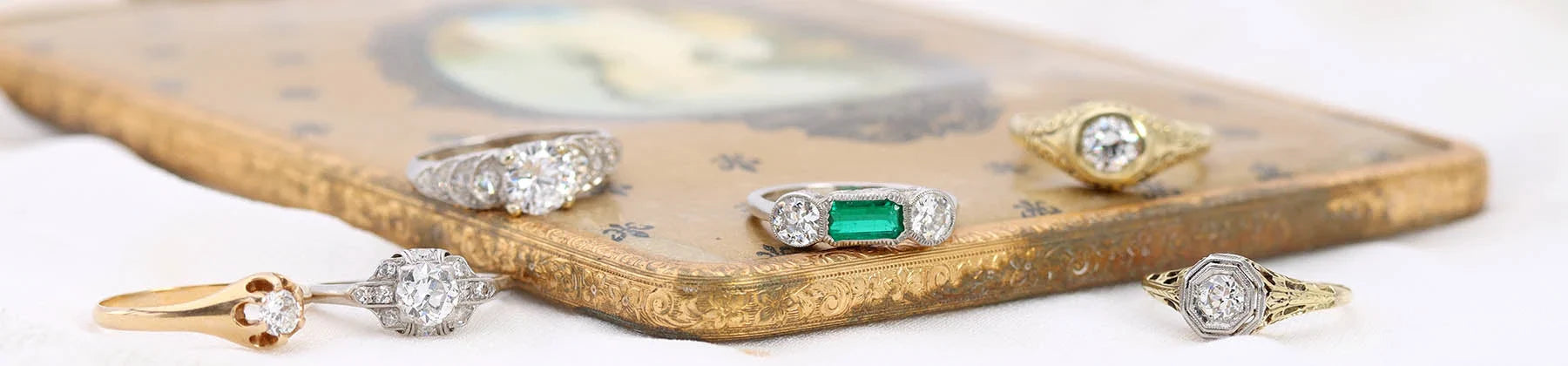 Banner image of three vintage engagement rings