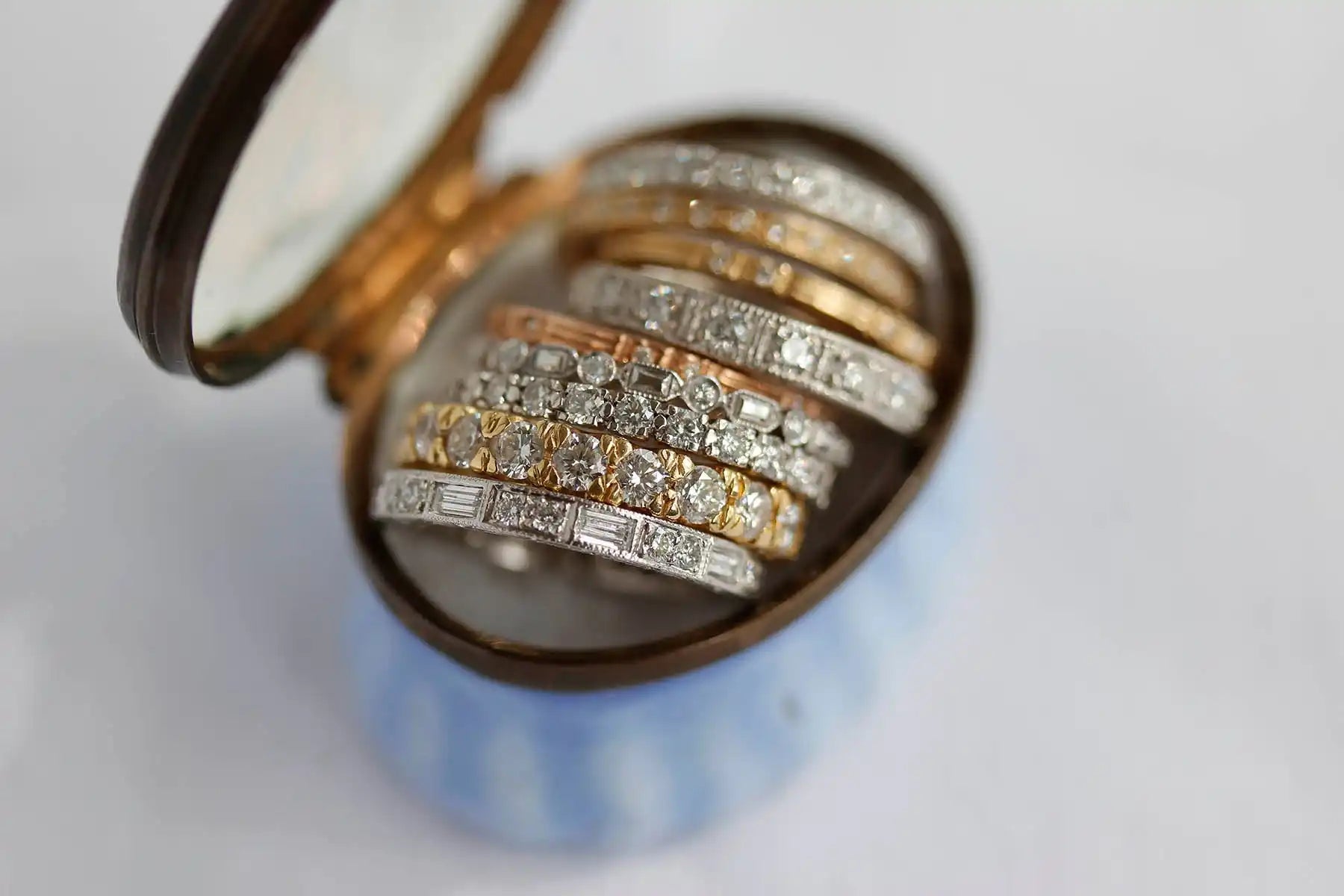 Diamond-encrusted rings stacked together in alternating gold and silver bands.