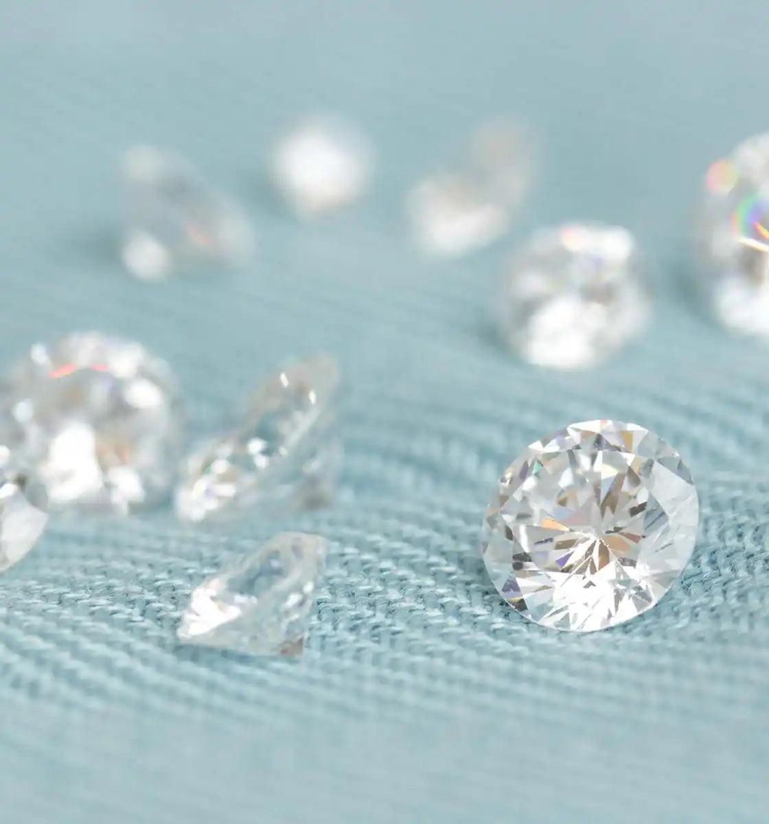 Sparkling diamonds scattered on a textured surface.