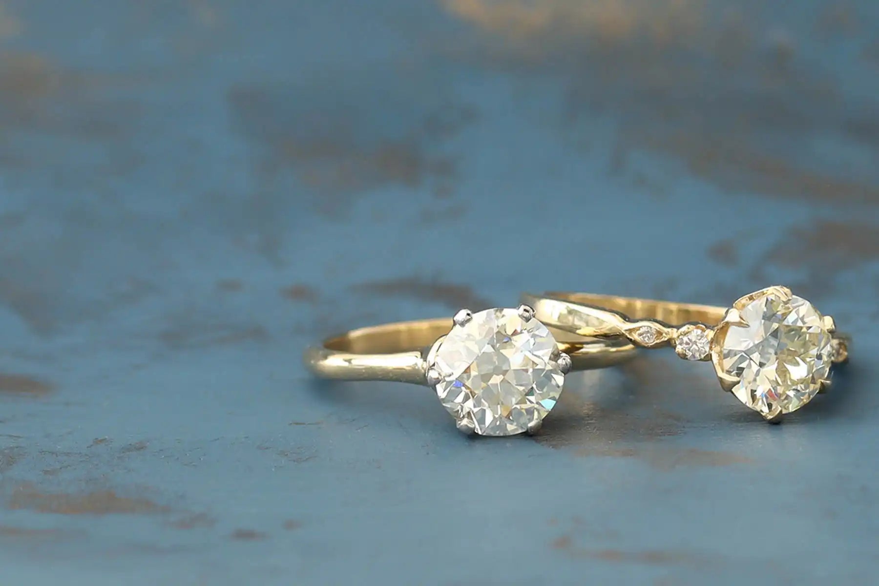 Two diamond solitaire rings with gold bands.