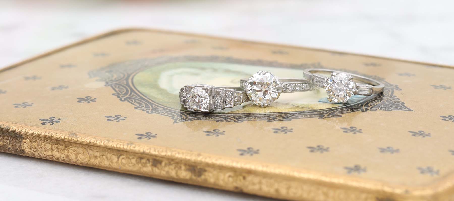 Banner image of three vintage engagement rings
