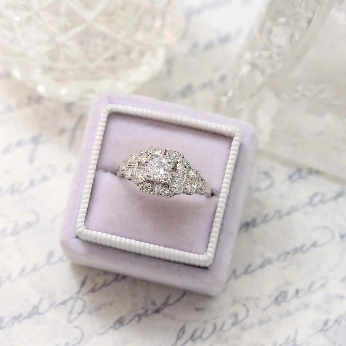 Vintage-style diamond engagement ring with an ornate Art Deco design in white gold or platinum.